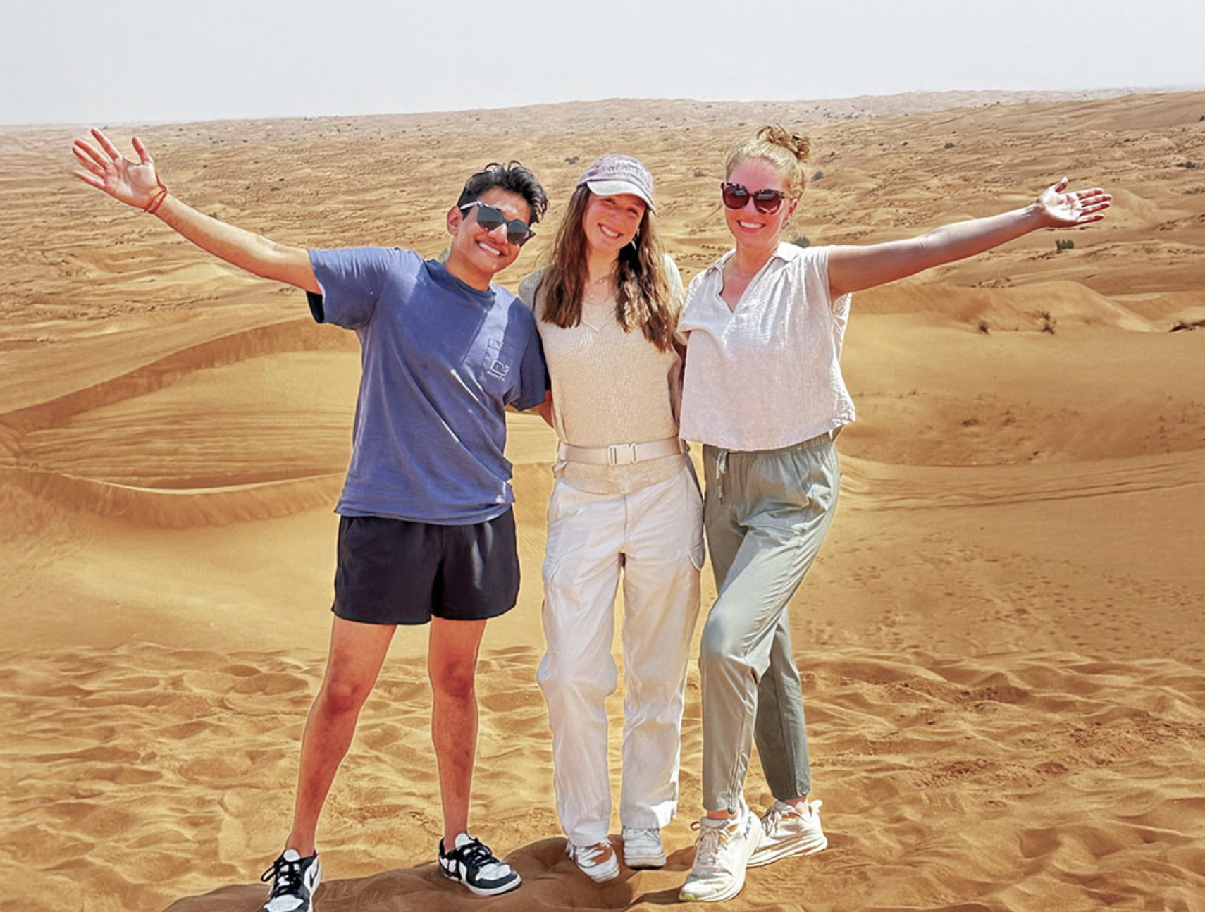 Three pharmacy students pose in the desert while on a global rotation.